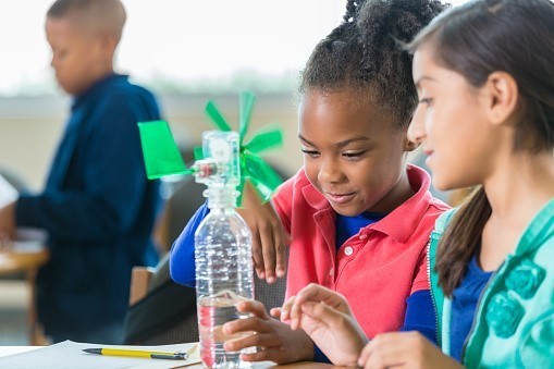 Two students doing a wind experiment